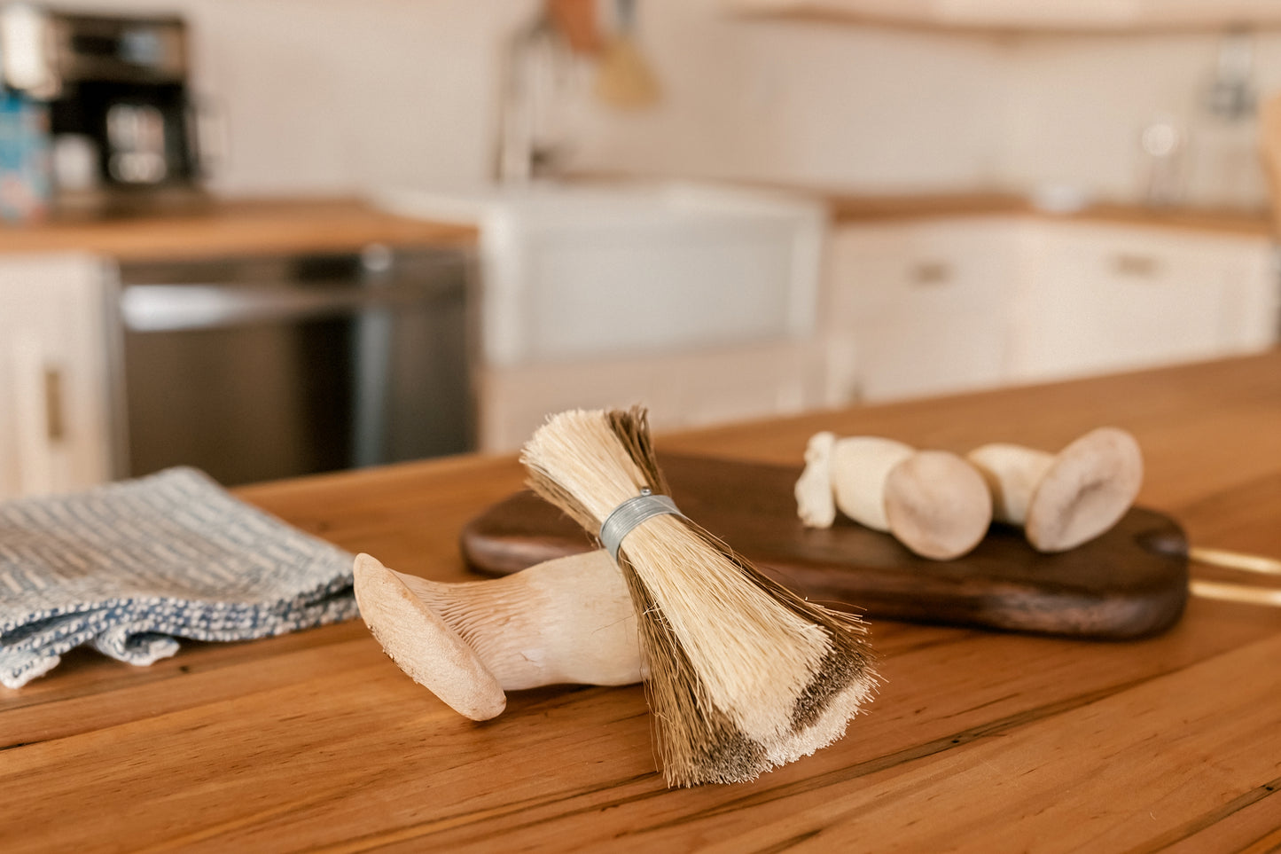 Metal wrapped brushes and brooms