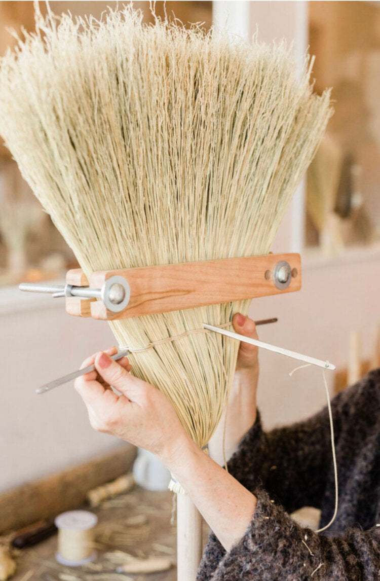 Close-up-of-Cynthia-working-on-broom