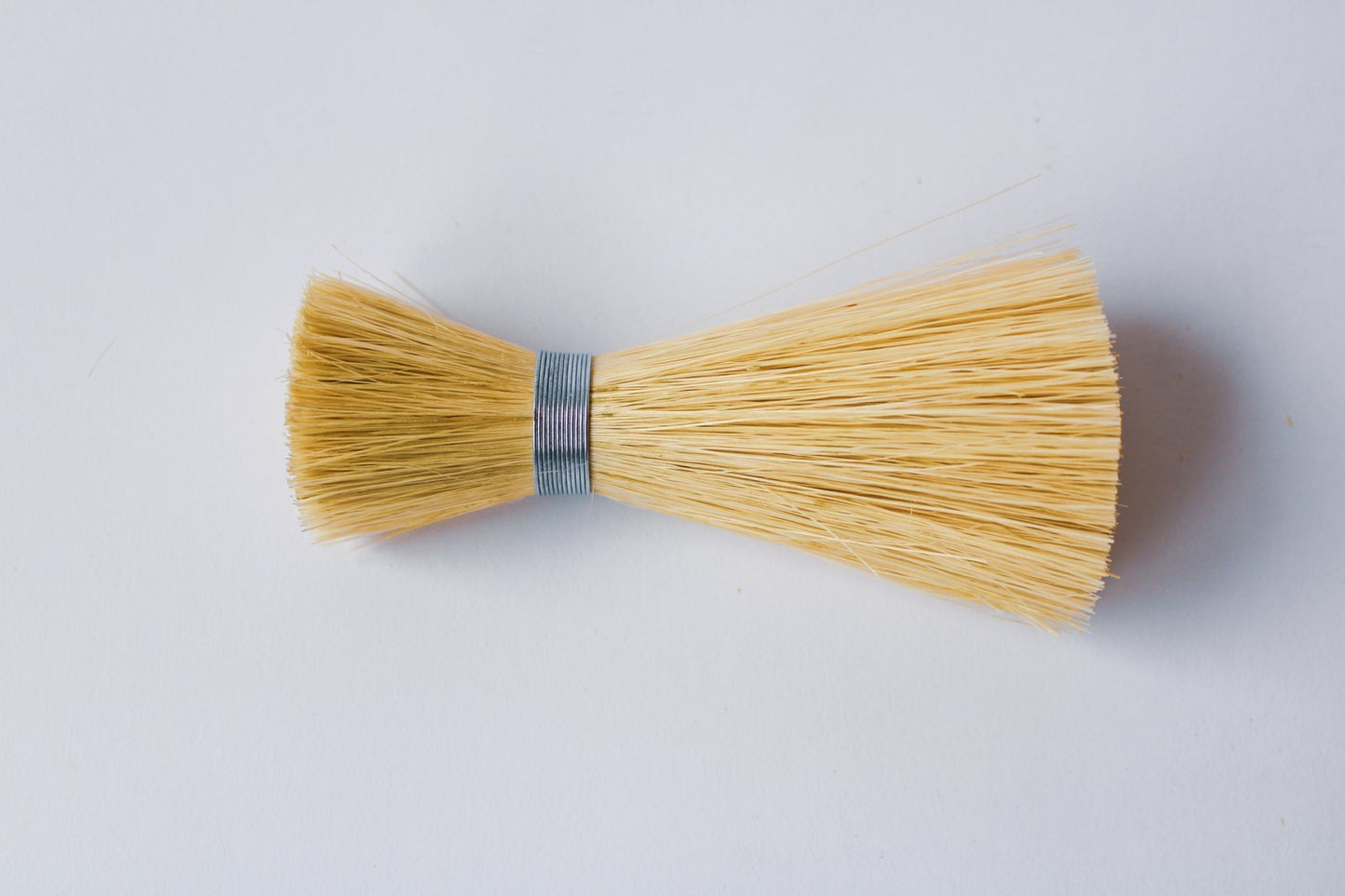 Metal wrapped brushes and brooms