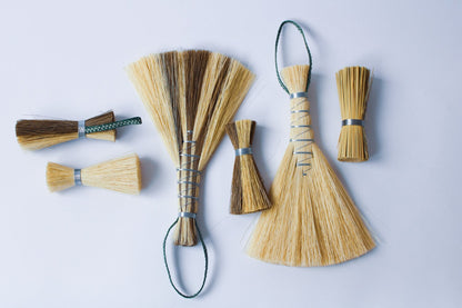 Metal wrapped brushes and brooms