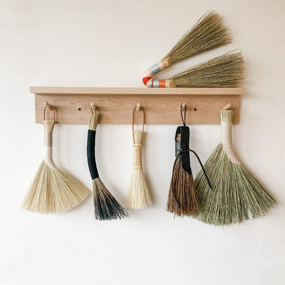 Many-hand-brooms-hanging-on-wall