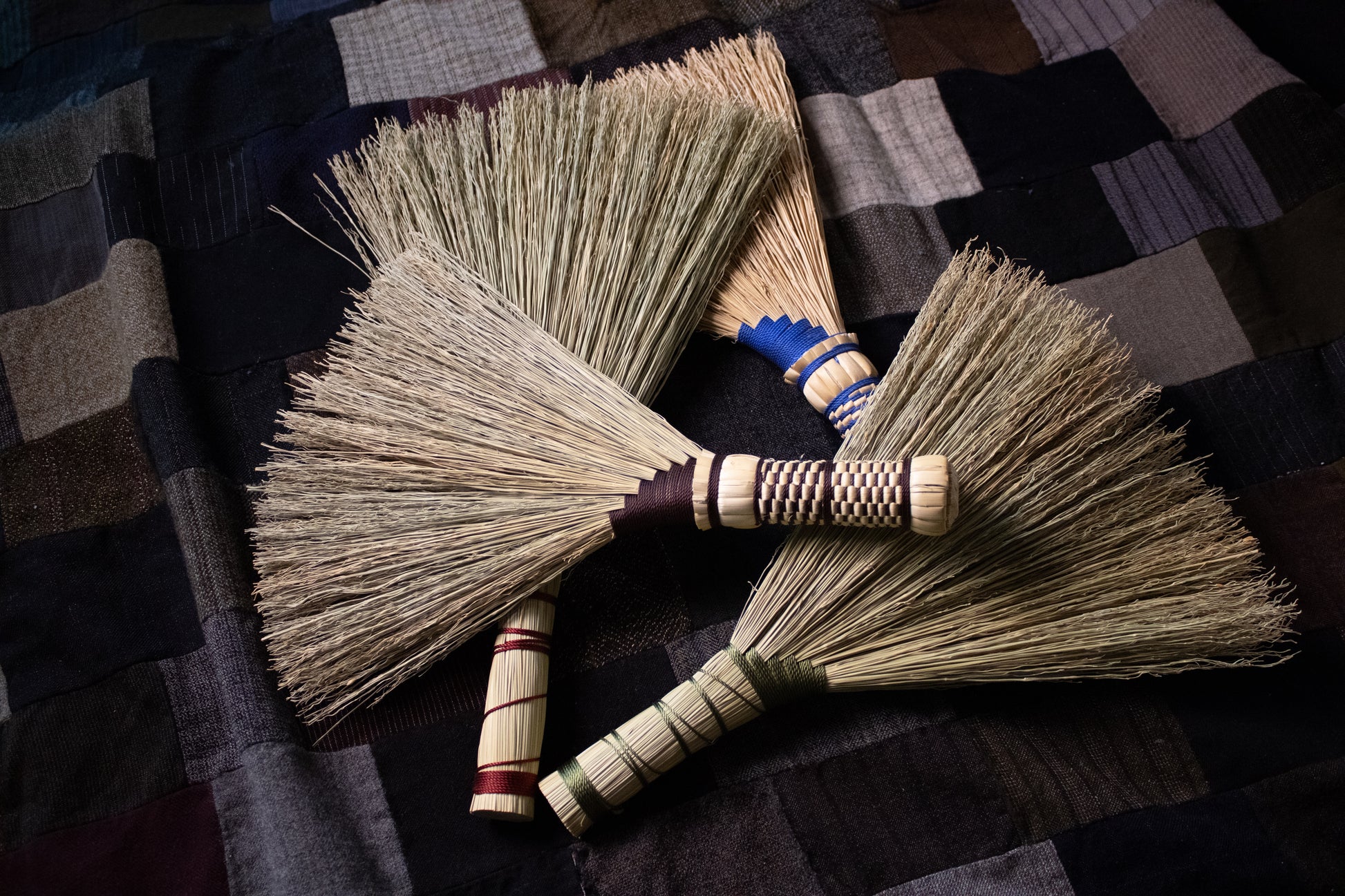 Four-handbrooms-with-blue-brown-green-red-threaded-handles