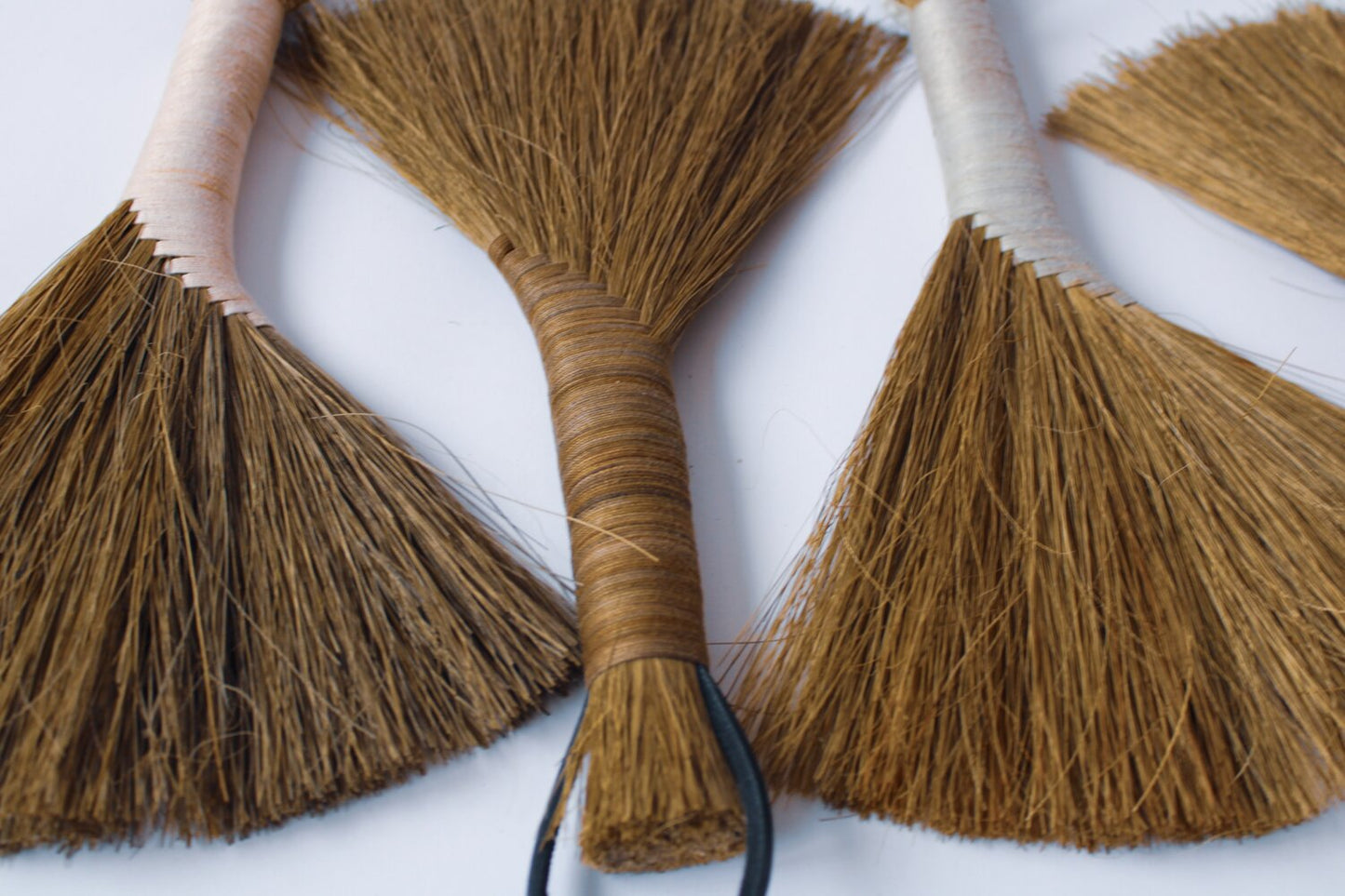 Many-dark-Tampico-handbrooms-with-brown-and-white-threaded-handles 