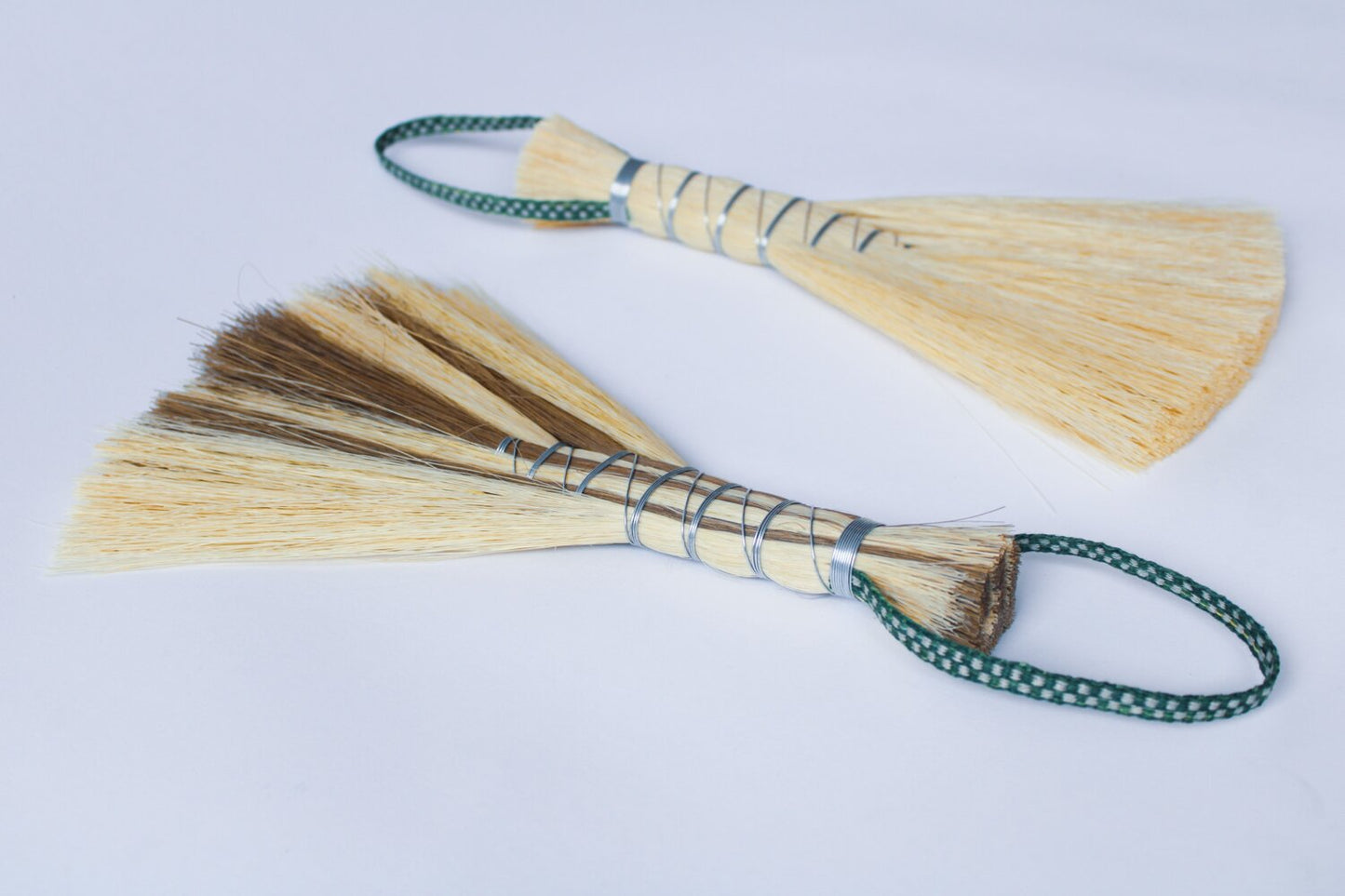 Metal wrapped brushes and brooms