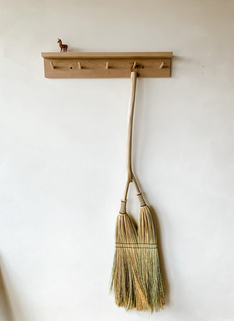 double-handbroom-hanging-on-the-wall