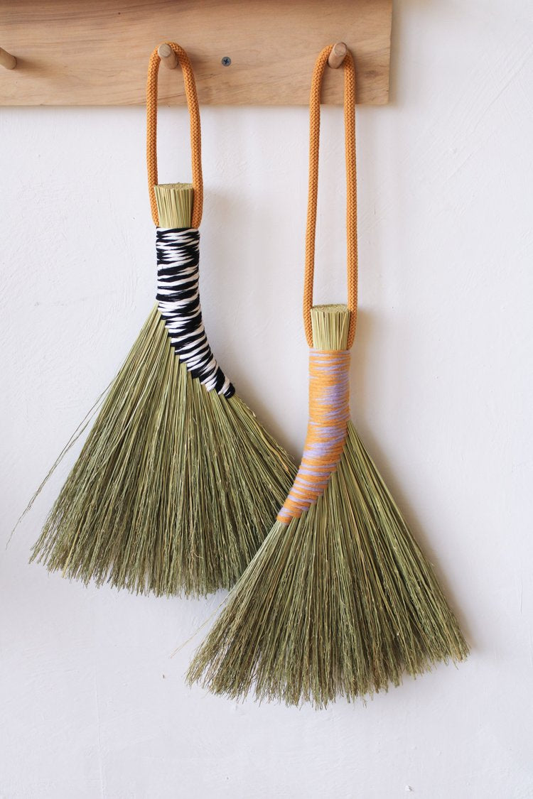 Two-two-tone-handbrooms-hanging-on-the-wall