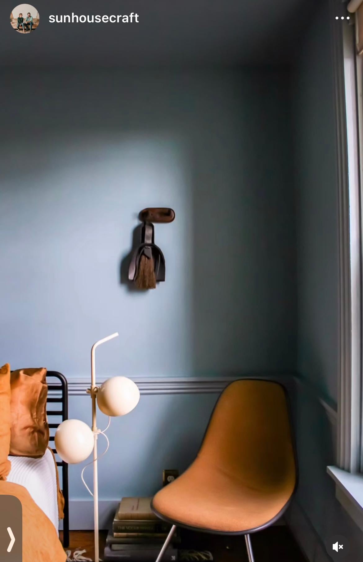 Nesting-Broom-with-black-dustpan-hanging-on-the-wall