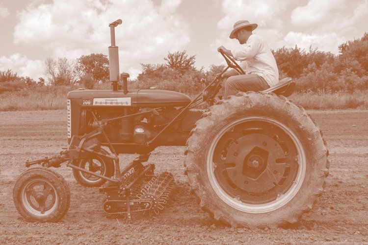 Monochrome-photo-of-farmer-on-tracker