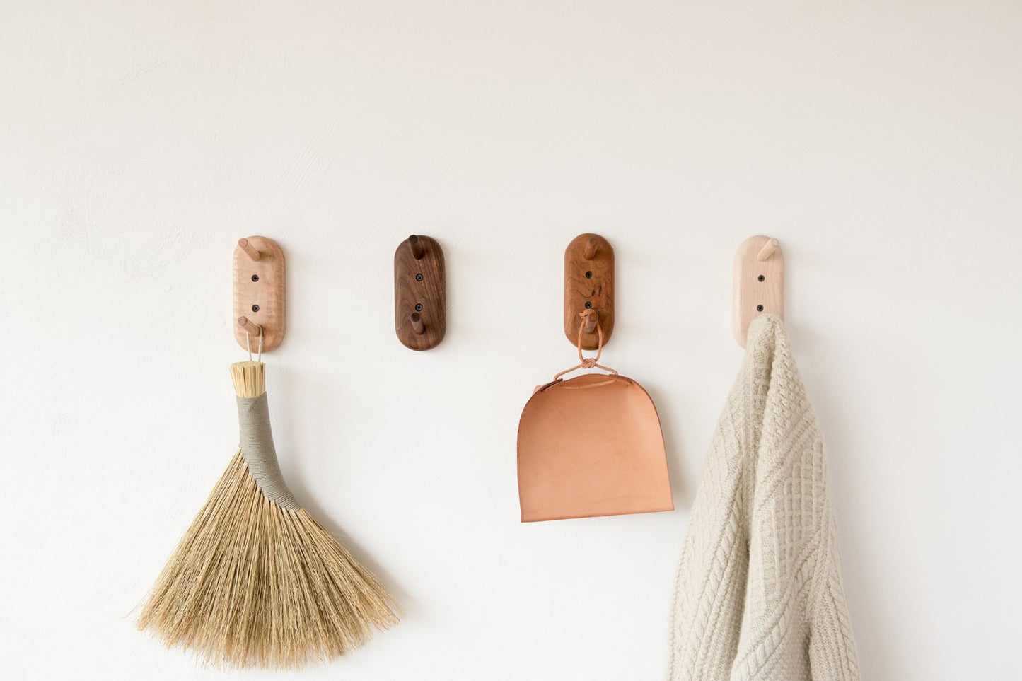 Hand-brush-dustpan-and-towel-hanging-on-Pilly-racks