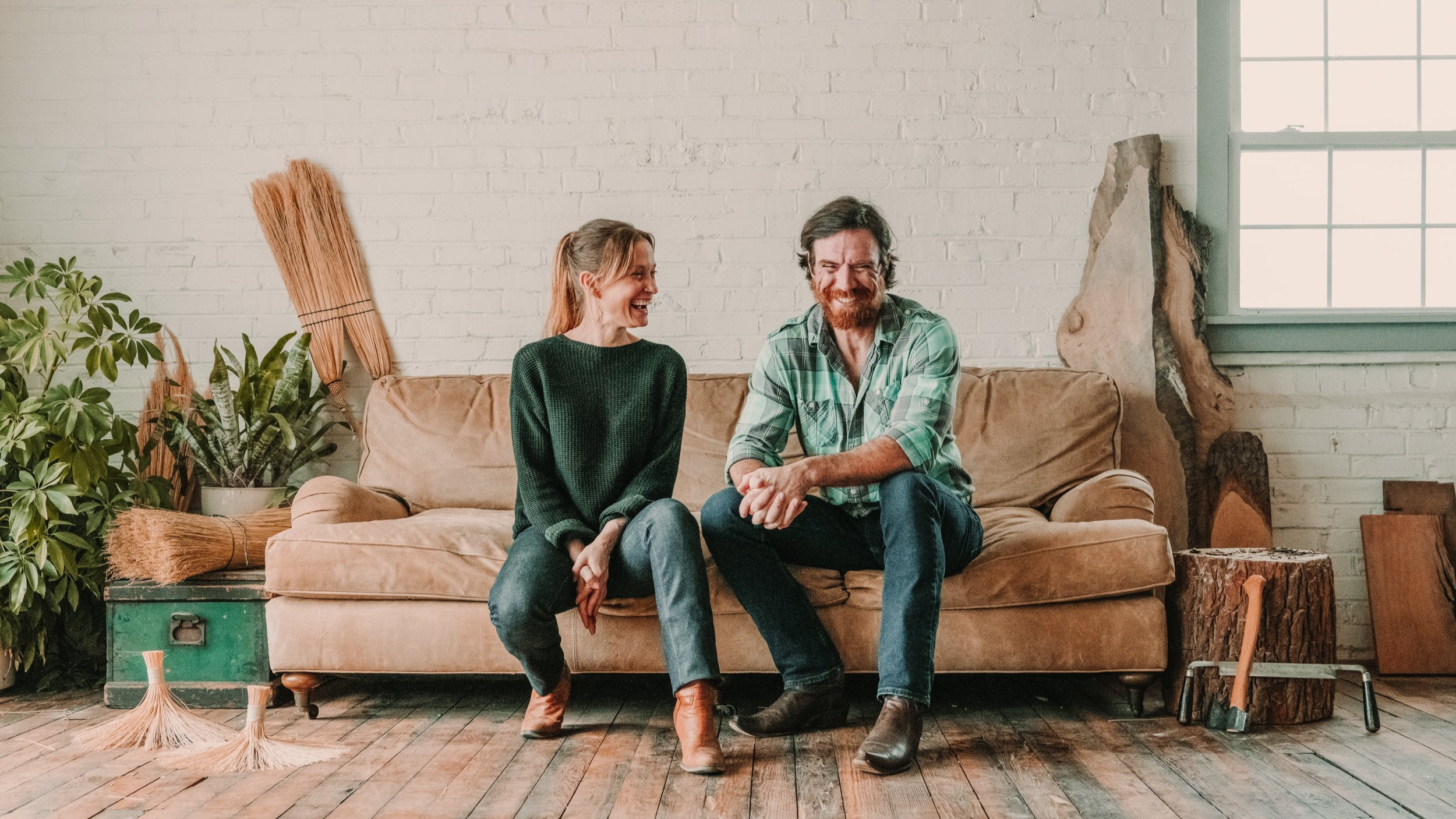 Cynthia-and-Doug-sitting-on-couch-in-workshop