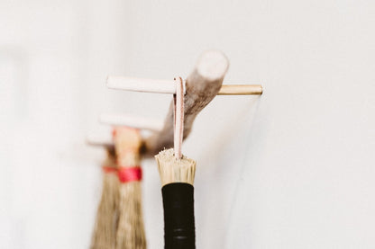 peg-rack-with-brooms-hanging-on